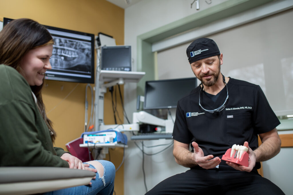 Dr Schroeder an oral surgeon at Associated Oral and Maxillofacial Surgeons working with a patient