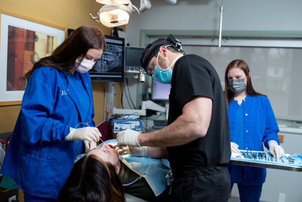 Dr Schroeder an oral surgeon at Associated Oral and Maxillofacial Surgeons working with a patient