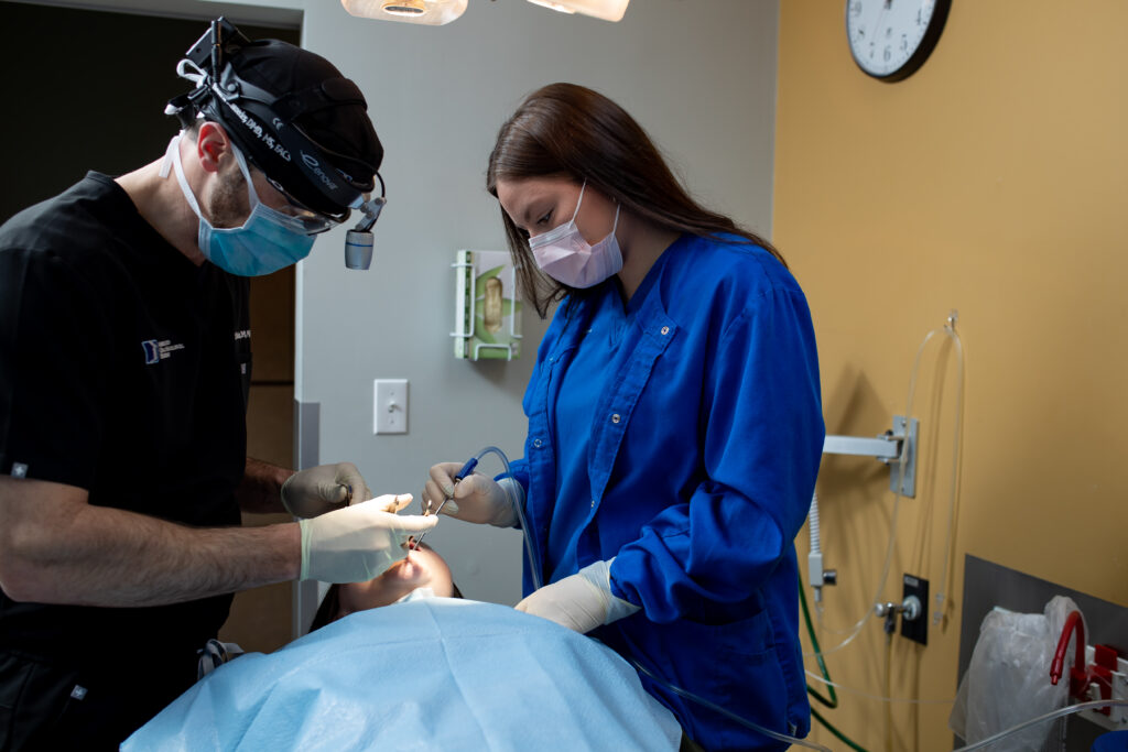 Dr Schroeder an oral surgeon at Associated Oral and Maxillofacial Surgeons working with a patient