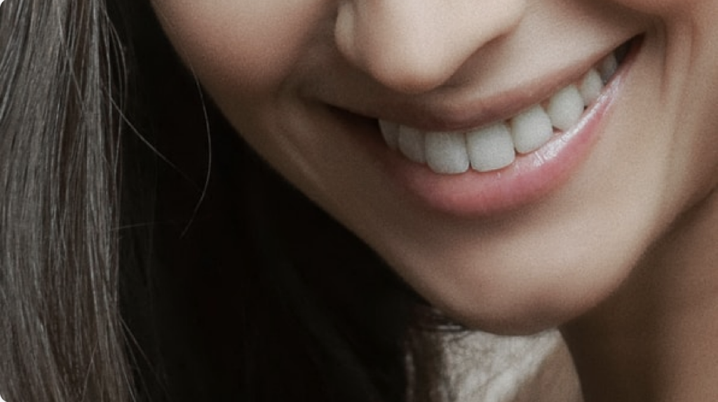 woman smiling after her oral surgery procedure