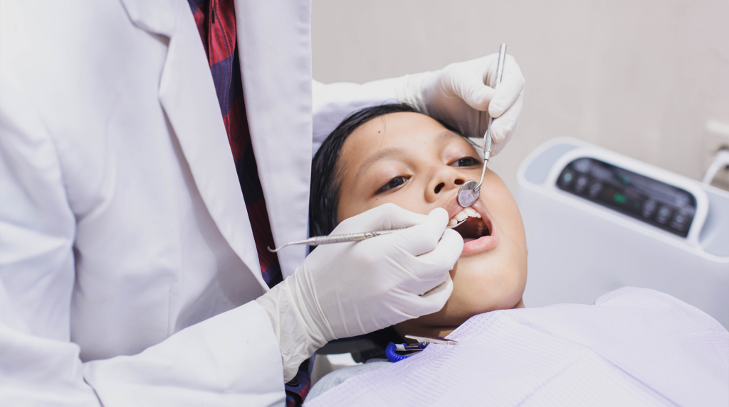 kid getting his teeth checked by an oral surgeon